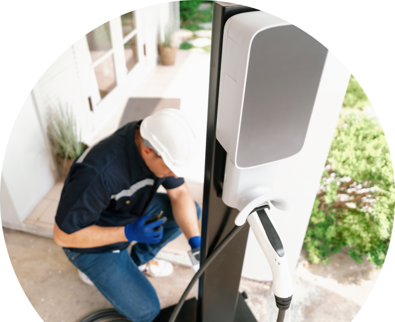 Home service electrician from Anchor Home Comfort installing an EV charger fixed to a vertical post near a residential entryway. Home service electrician from Anchor Home Comfort installing an EV charger fixed to a vertical post near a residential entryway.