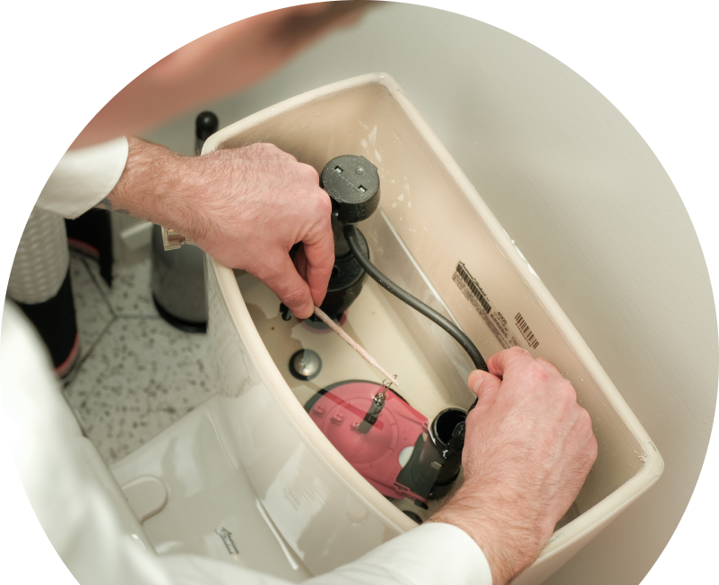 Anchor Home Comfort plumbing specialist adjusts internal components of a toilet tank, with tile flooring visible in the background. Anchor Home Comfort plumbing specialist adjusts internal components of a toilet tank, with tile flooring visible in the background.