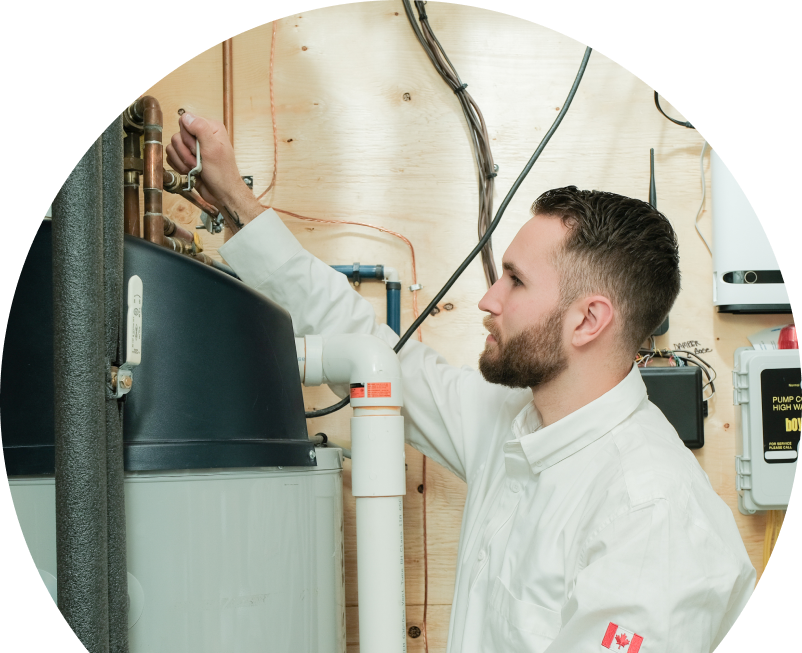 Anchor Home Comfort water heater specialist adjusts piping on a large residential unit during a repair service, with exposed wood paneling and mounted utility components in the background. Anchor Home Comfort water heater specialist adjusts piping on a large residential unit during a repair service, with exposed wood paneling and mounted utility components in the background.